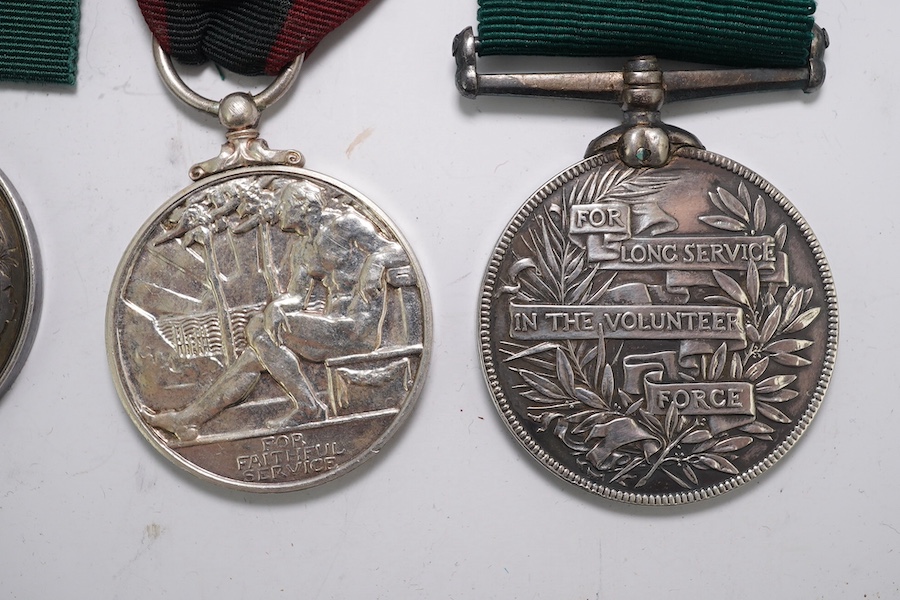 Four assorted Service medals; Vict unnamed Volunteer Long Service medal; GV Colonial Auxiliary Forces Long Service medal (disc only) to E.S.Ware; ERII ISM to Thomas Edward Downes; ERII ISM to William Henry Sharratt. Cond